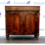 19th century flame mahogany side cupboard with frieze over two panelled doors on turned legs. 91H