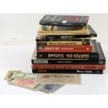 Selection of books on Asian militaria together with a printed world map and banknotes