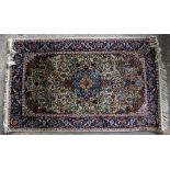 Part silk Persian green ground rug, central floral medallion with scrolling floral motifs
