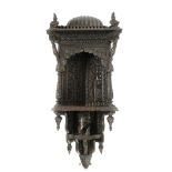 Anglo-Indian carved hardwood wall hanging corner shelf, with domed top above caryatid and Corinthian