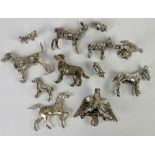 Collection of 12 silver plated models of animals, to include dogs, eagle, deer, horses, kitten