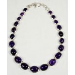 Amethyst and silver graduated necklace, oval cabochon amethysts in silver rub-over settings, with