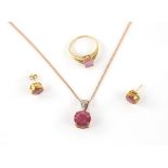 Ruby and diamond pendant, with a round cut ruby measuring 11.19mm diameter, in a four claw