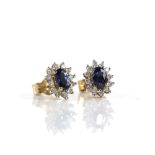 Sapphire and diamond cluster earrings, set with oval cut sapphires and round brilliant cut diamonds,