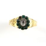 Victorian paste cluster ring, central oval white paste stone surrounded by green paste stones,