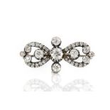 Old cut diamond brooch, central old cut diamond estimated weight 0.61 carats, with four other