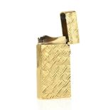 Dunhill gold plated cigarette lighter, textured surface, made in England, marked on base Dunhill