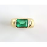 Contemporary emerald ring, rub over set rectangular step cut emerald, estimated weight 2.77