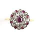 Antique ruby and diamond circular cluster ring, central octagonal cut ruby encompassed by a double