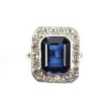 Synthetic sapphire and diamond ring, central rectangular step cut sapphire 12.4 x 9.7mm, set with in