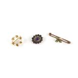 Three brooches, a Victorian foil backed amethyst and seed pearl brooch, testing as 15 ct, 1.7 x 2cm,