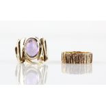 Two vintage rings, one set with oval cabochon cut amethyst, rub over set with textured shoulders,