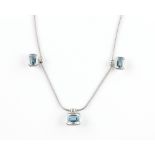 Modern blue topaz and diamond necklace, comprising three octagonal cut blue topaz in rub over