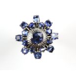 Sapphire dress ring, central oval cut sapphire, high set, with a white metal textured surround, with