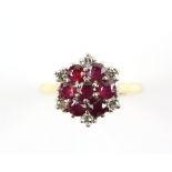 1960's ruby and diamond cluster ring, seven round cut rubies, claw set with six round brilliant