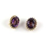 Pair of amethyst and diamond oval cluster earrings, featuring large oval faceted amethysts,