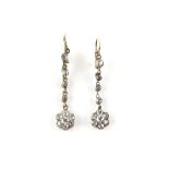 A pair of Edwardian drop earrings, set with old cut diamonds, floral cluster terminations, estimated