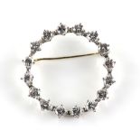 Diamond wreath brooch of open circular design, set with sixteen round brilliant cut diamonds,