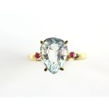 Aquamarine and ruby ring, pear shaped aquamarine, estimate weight 2.62 carats, flanked by round