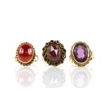 Three paste set rings, one purple paste set stone ring, mount testing as 18 ct, size P, a red