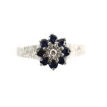 1970's floral cluster ring, set with eight round cut sapphires and a single cut diamond, mount