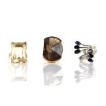 Three rings, an asymmetric smokey quartz ring, size N 1/2, mount stamped 14 ct, with a citrine