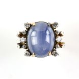 Star sapphire and diamond ring, central oval cabochon cut star sapphire, with a six ray star,