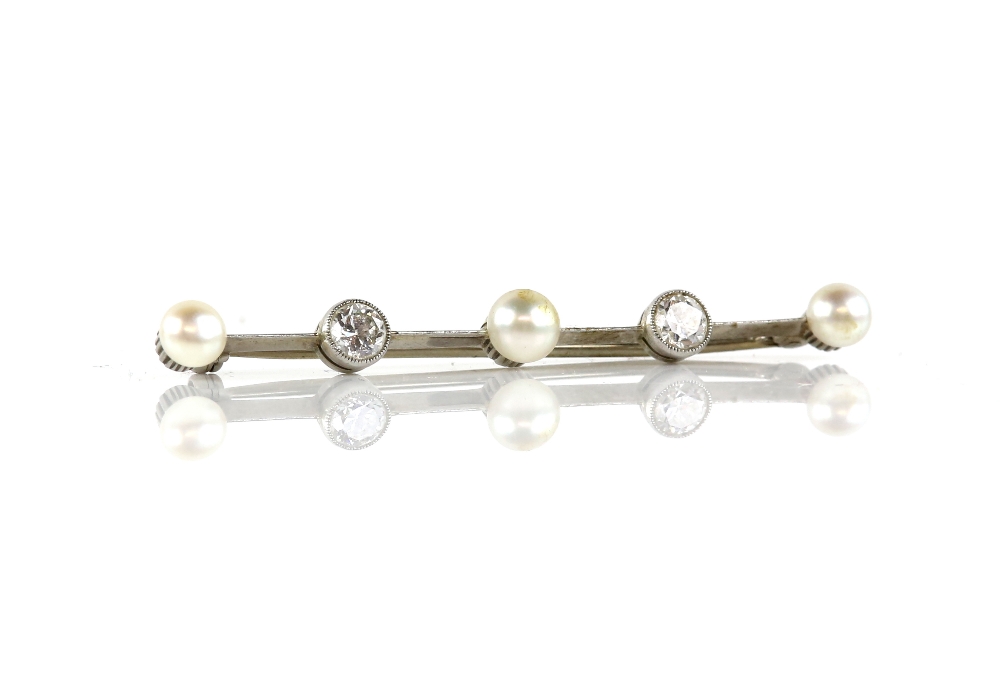 Diamond and pearl bar brooch, set with three white pearls and two transitional cut diamonds,