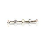 Diamond and pearl bar brooch, set with three white pearls and two transitional cut diamonds,