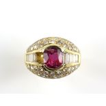 Ruby and diamond bombé dress ring, with a central oval cut ruby weighing an estimated 1.71 carats,