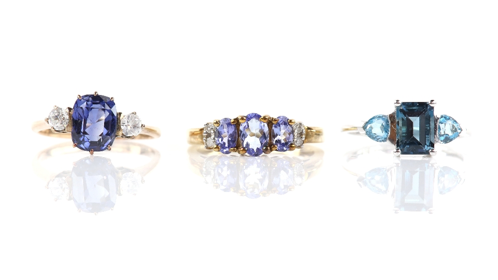 Three gem set rings, including a synthetic blue sapphire and white sapphire three stone ring, size J