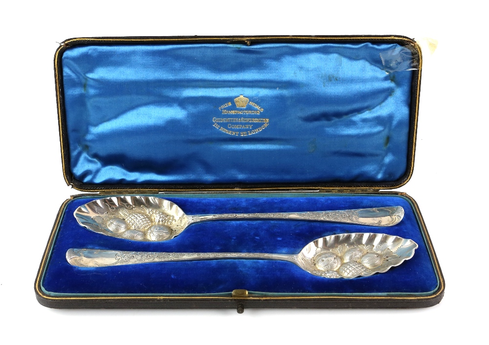 Pair of George III silver berry spoons, with engraved and embossed decoration, maker's mark 'SG'