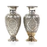 Persian silver pair of vases, the baluster bodies chased with wild animal cartouches and foliate
