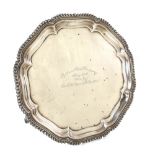 George V silver presentation salver with gadrooned serpentine rim on three scroll feet, by S.