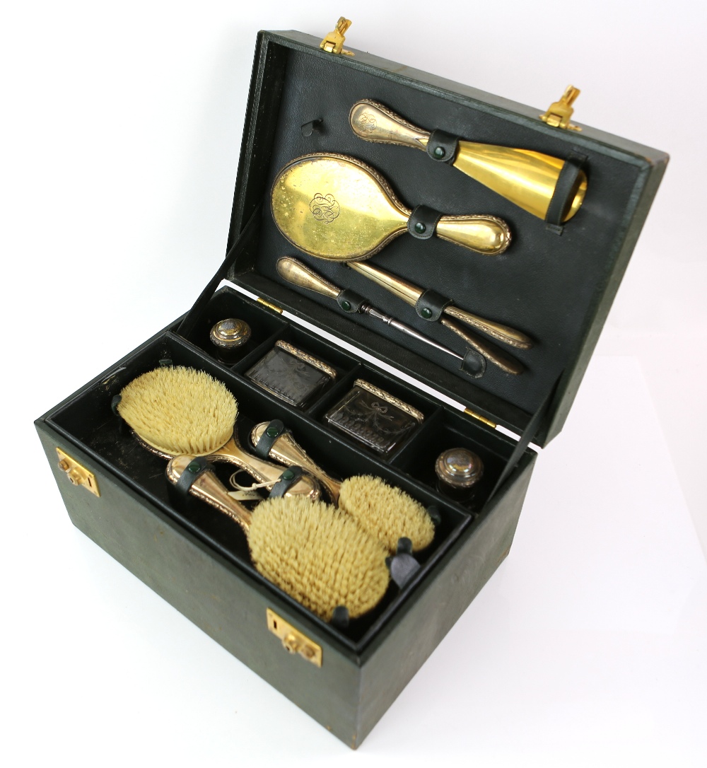 Parcel-gilt silver-plated travel dressing table set, comprising dressing table bottles, brushes,