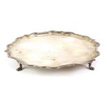 Modern silver salver, with shaped border on four flattened hoof feet, by Roberts & Belk Ltd.,