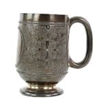Victorian silver mug with embossed scrolling foliate decoration, on round foot, by H J Lias & Son,