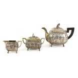 19th century Hanau silver three-piece bachelor tea-service, each body parcel-gilt with four panels