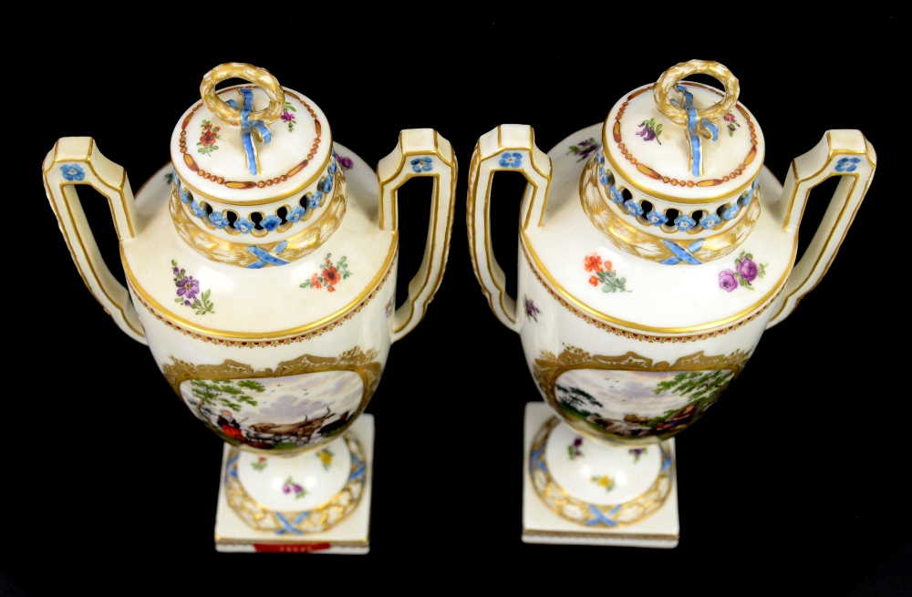 A pair of two handled Continental porcelain urns and covers with central cartouches painted with - Image 3 of 5