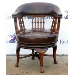 Mahogany and brown leather upholstered swivel action chair Splits to leather knocks, scratches and