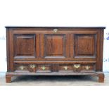 An early 18th century converted oak mule chest with two short drawers under cupboards on bracket