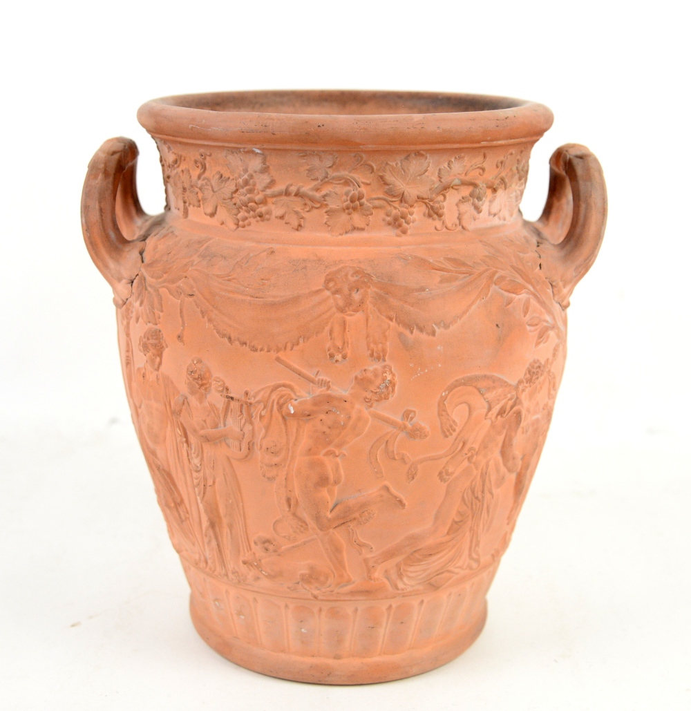 Wedgwood terracotta two handled urn moulded with Bacchanalian figures after the antique, the base