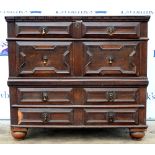17th century style oak chest with geometric moulded panelled front and four long drawers raised on