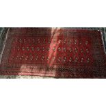 Caucasian red ground rug, repeating geometric medallions within multi geometric borders, 288 x 139cm