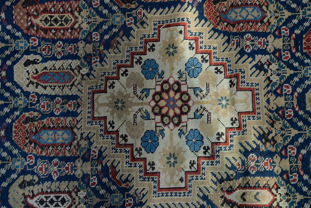 Tribal carpet with repeating Boteh motifs and three geometric medallions on a blue ground, within - Image 2 of 4