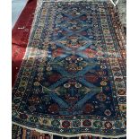 Turkish blue ground rug, with five pole medallion and stylised floral motifs on a dark blue ground
