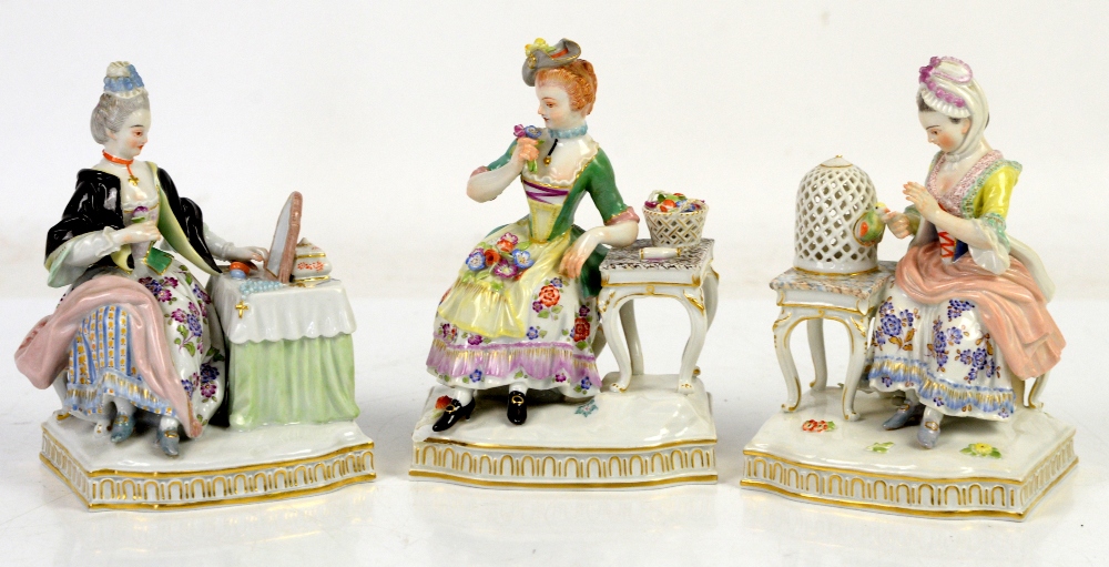 AMENDED DESCRIPTION Three Meissen figure groups each one modelled as a lady seated at a table,