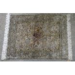 Persian Isfahan style part silk rug, with floral and bird design on a cream ground contained
