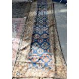 Persian blue ground runner, with repeating floral motifs within floral borders, 400 x 92cm