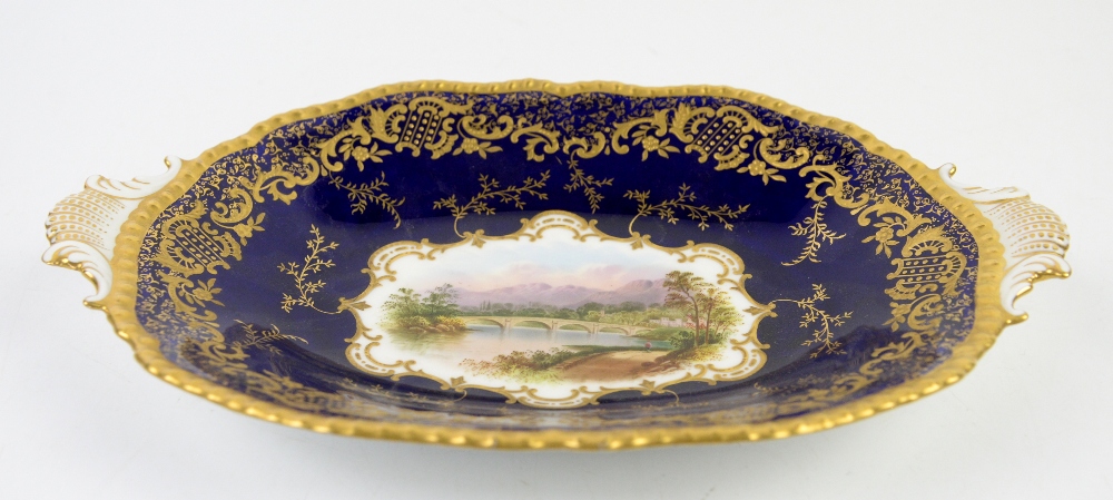 Coalport oval two handled dish in cobalt with gilt decoration, the centre hand-painted with a